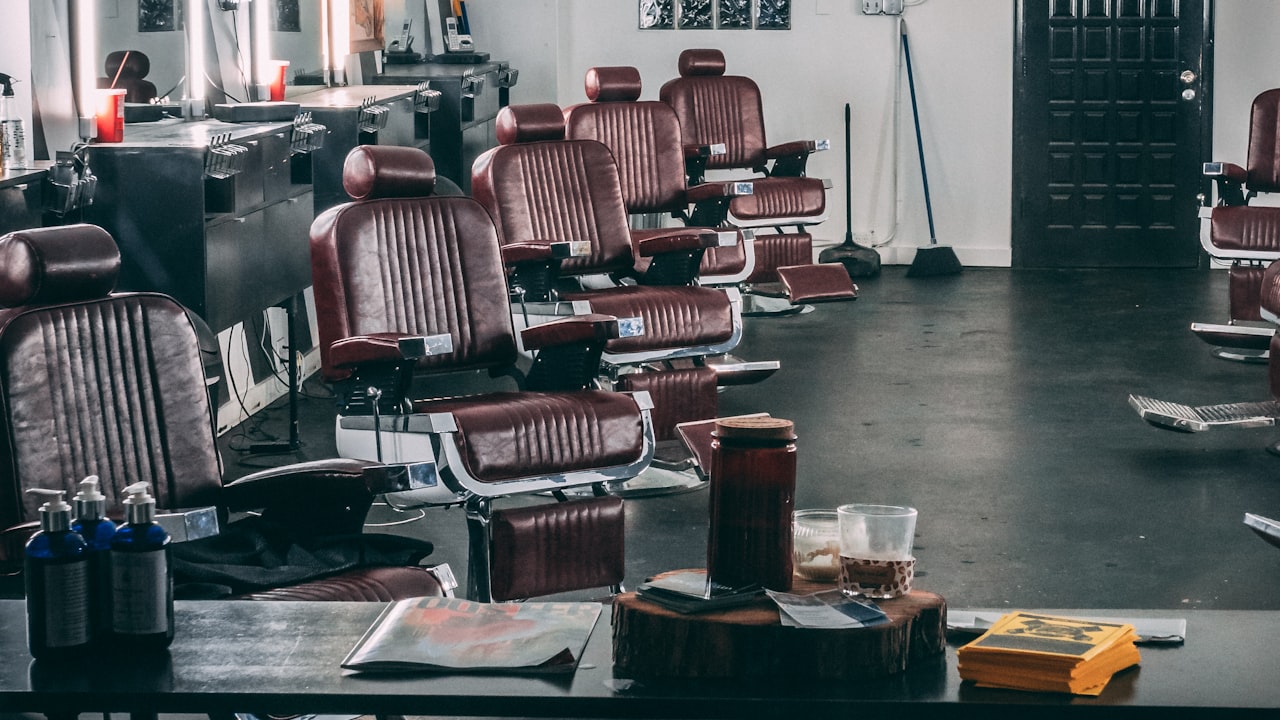 A row of empty barber chairs in a quiet shop before opening