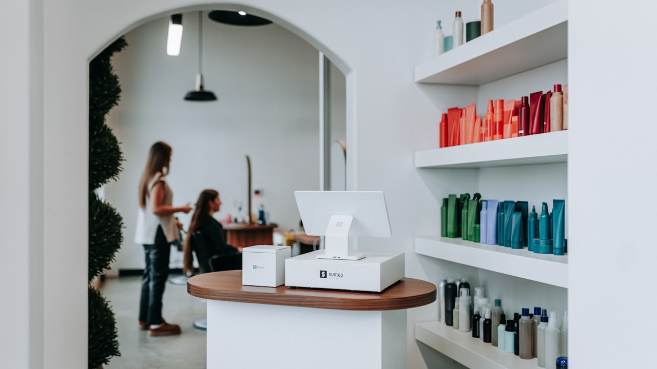 A modern hair salon interior with styling stations and retail products